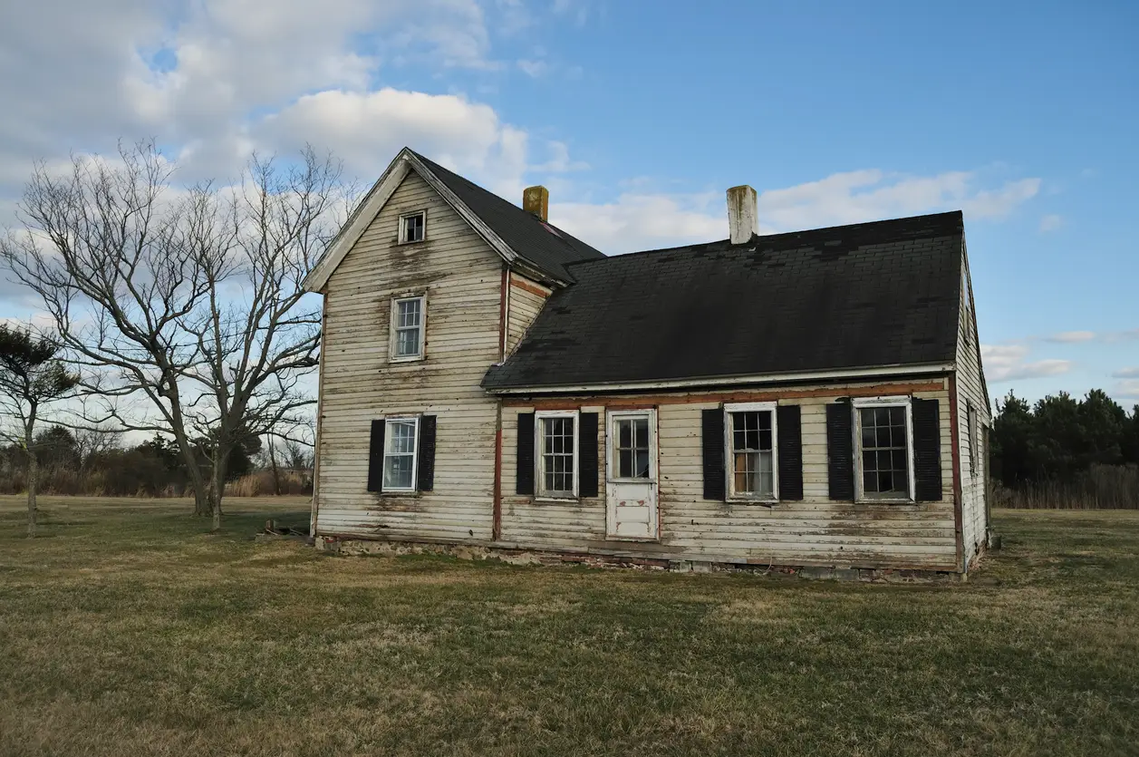 Old distressed property illustrating the risks and opportunities involved in buying a house as is.